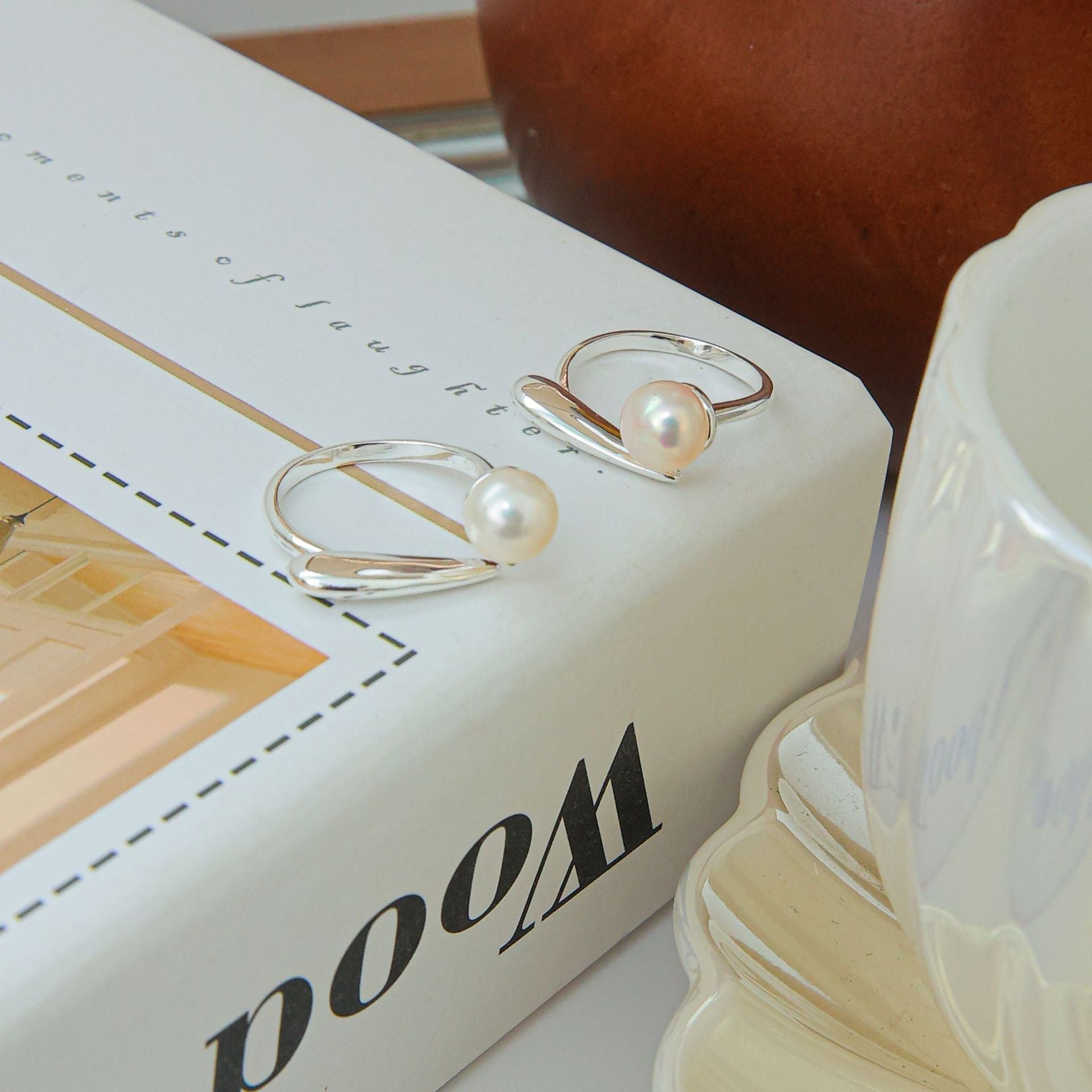 Sterling zilveren in elkaar grijpende parelring